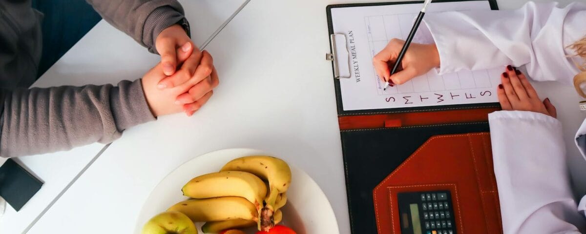 a doctor writing on a clipboard