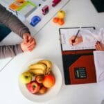 a doctor writing on a clipboard