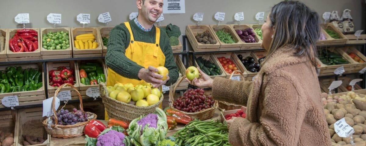 woman buying food at the greengrocers