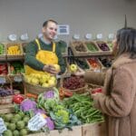 woman buying food at the greengrocers