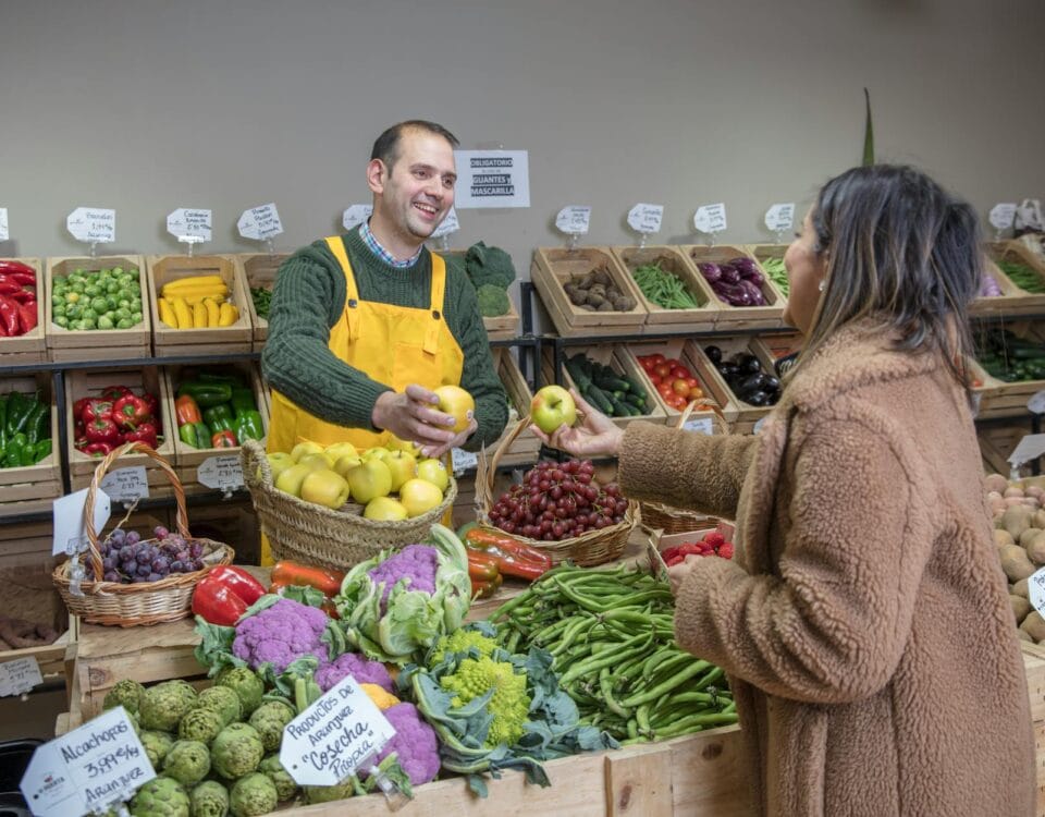woman buying food at the greengrocers