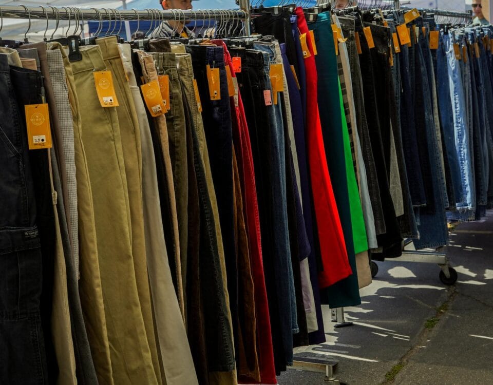 a rack of clothes with many different colors