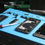 disassembled smartphone on repair workbench