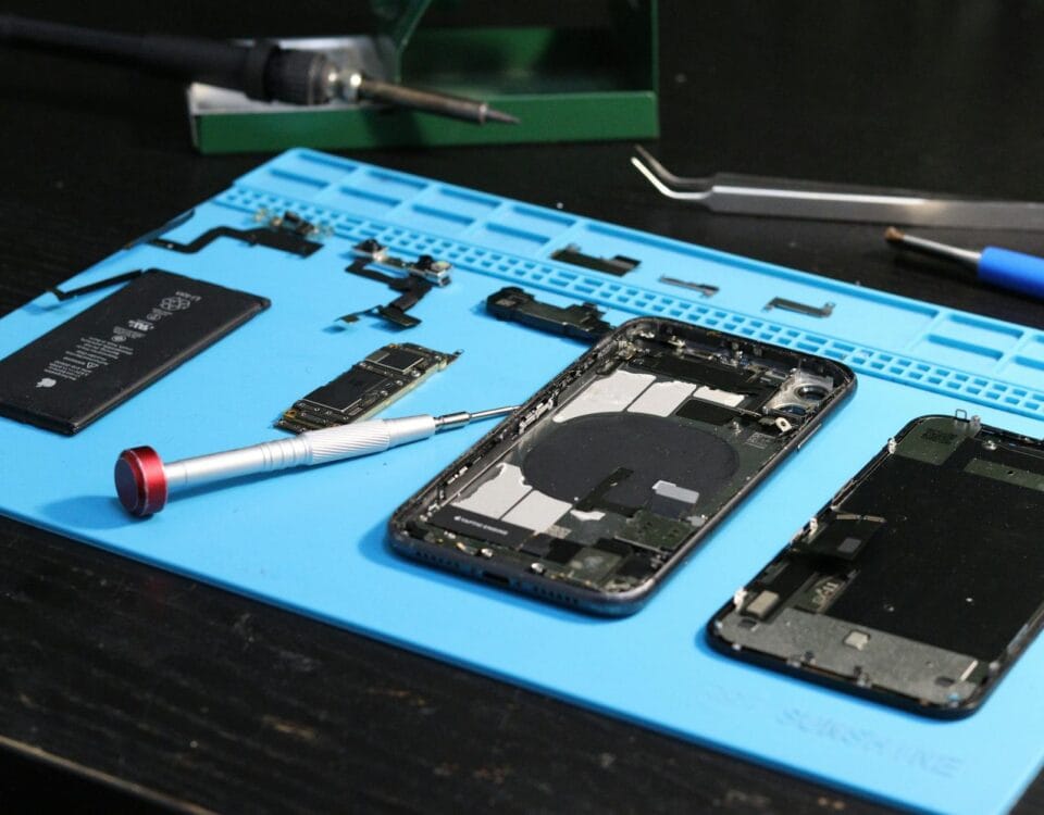 disassembled smartphone on repair workbench