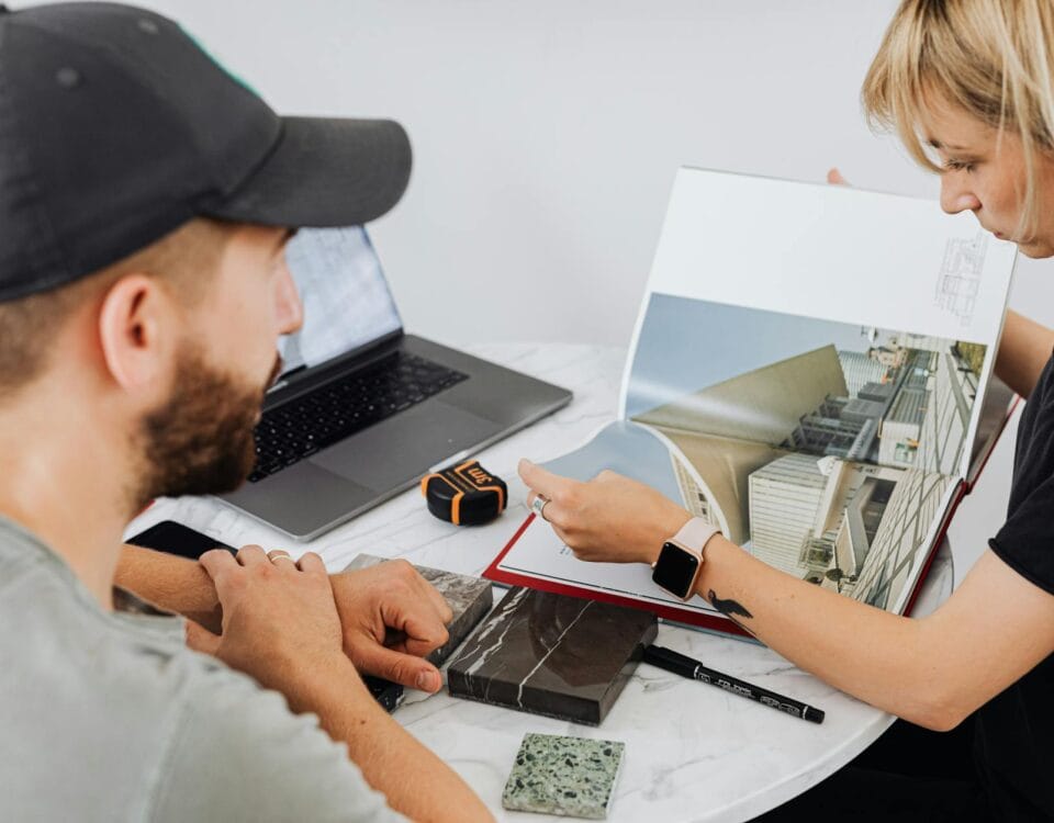 a man and a woman looking at a book
