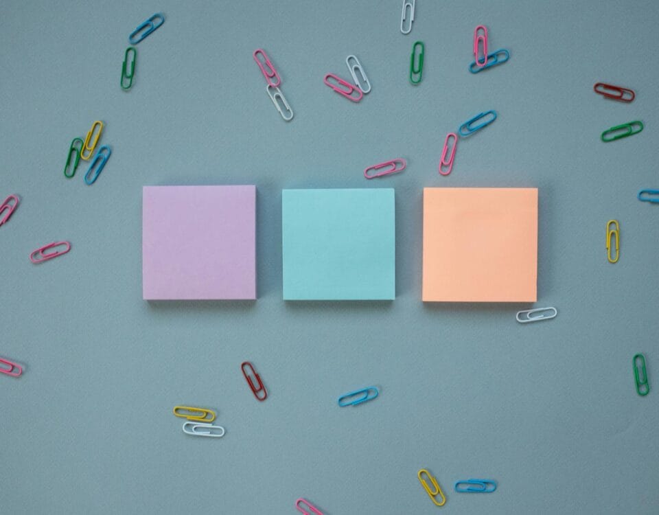 stacks of post it notes and paper clips