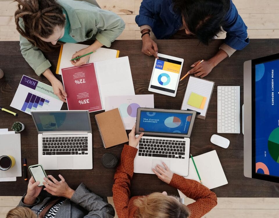 a group of people discussing charts