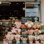 buckets of flowers displayed at a store